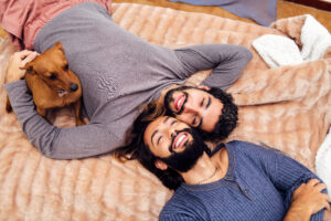 Image of gay couple holding their dog in NYC.