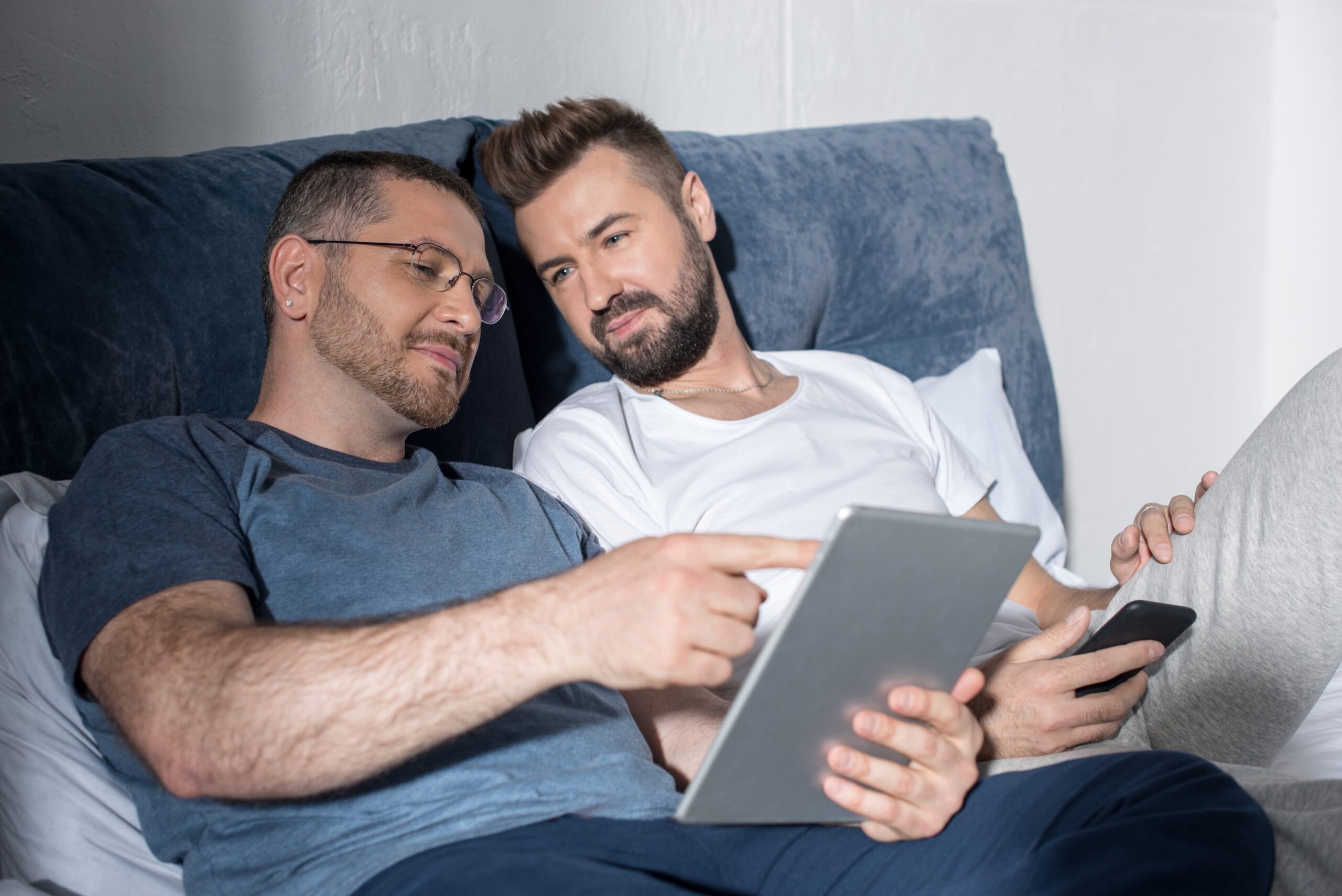 Gay couple showing signs of reconciliation during online couples therapy focused on rebuilding trust after infidelity in NYC.