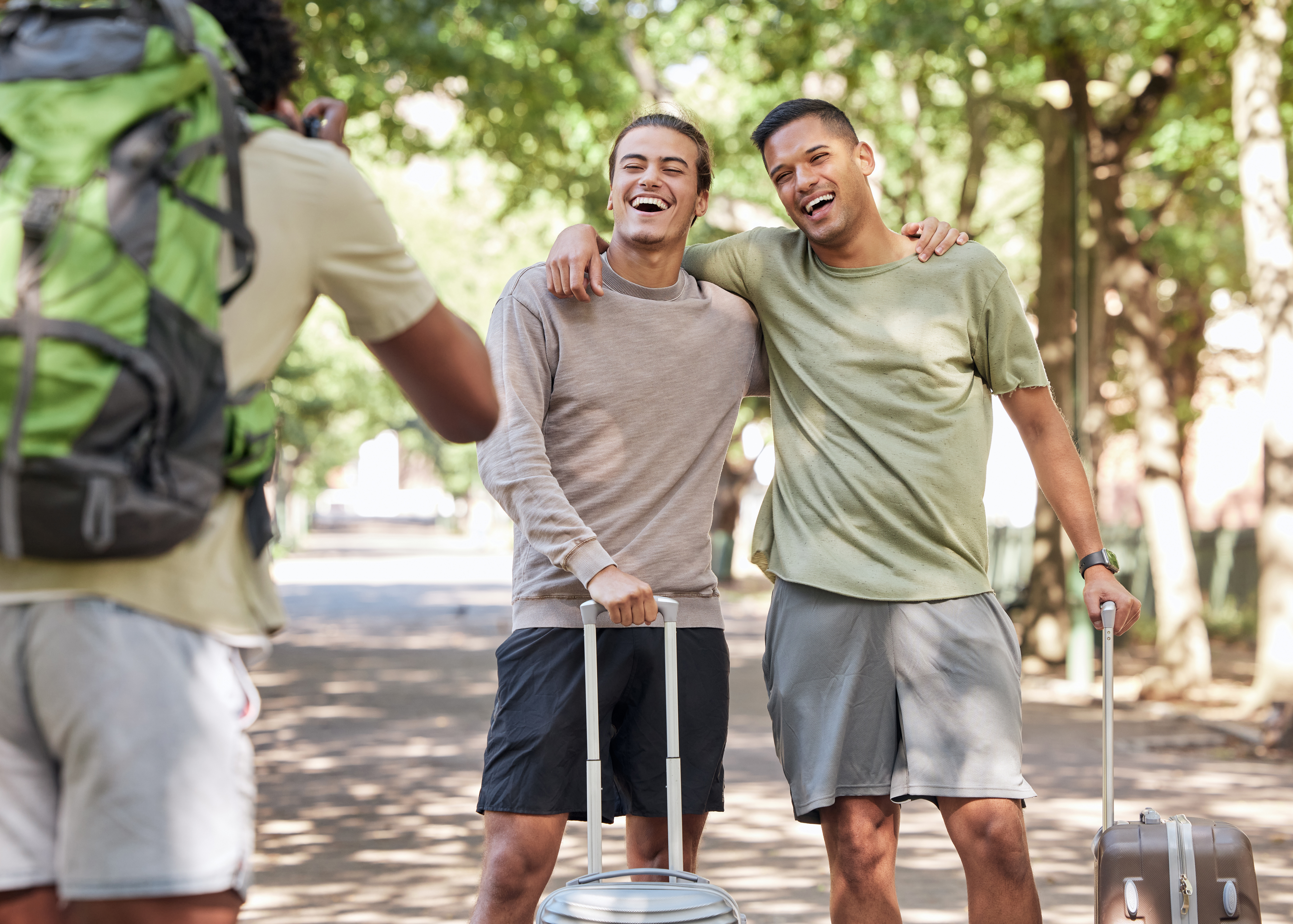Happy gay couple enjoying Central Park after successful online couples therapy, demonstrating restored connection and healthy relationship